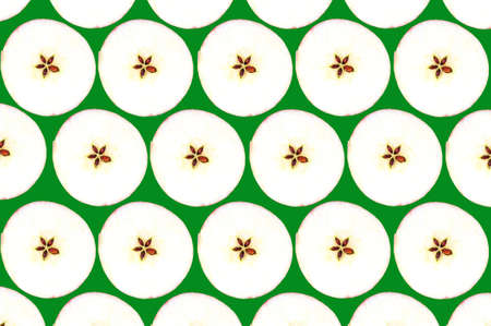 Collage of cut apples packed in rows against a green backgroundの写真素材
