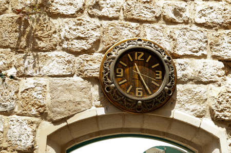 Old clock above the entrance to the old houseの写真素材