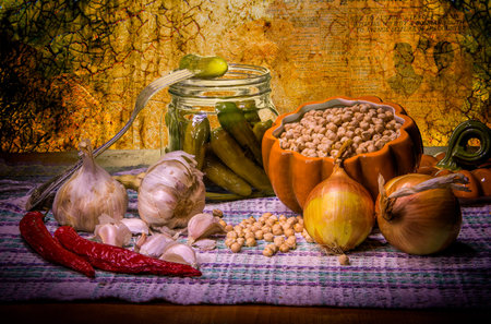 Glass jar with marinated cucumbers, onion, garlic and spicesの写真素材