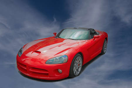 Isolation on a white background of a red, sports convertible with a folded topの写真素材
