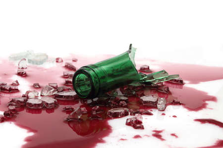 Bottleneck with broken glass on wineの写真素材