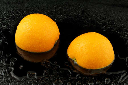 a divided apfelsine on black backgroundの写真素材
