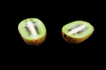 half wet kiwi on black backgroundの写真素材