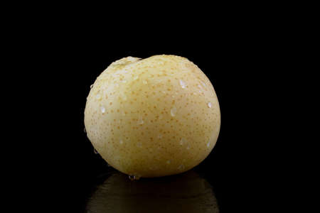 nashi pear with drops of water on black backgroundの写真素材