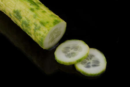 cucumber sliced on black backgroundの写真素材