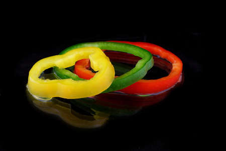 three rings paprika on black background with waterの写真素材