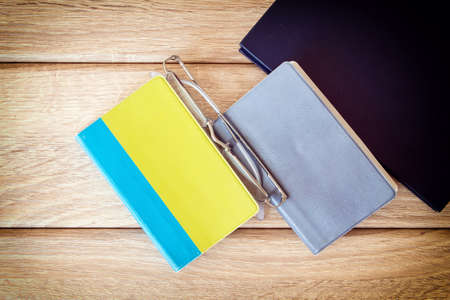 Three books on wood backgroundの写真素材