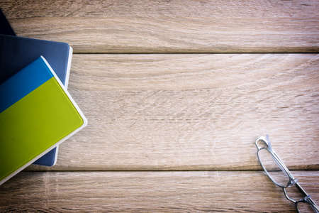 Three books on wood backgroundの写真素材