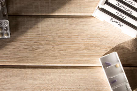 Tablet dispenser on a wood backgroundの写真素材