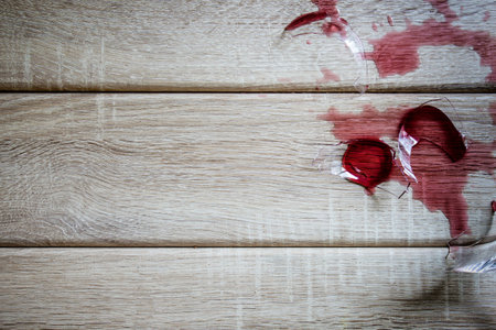 Broken wine glass on wooden backgroundの写真素材