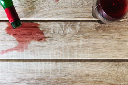 A wine glass and a wine bottle on wood backgroundの写真素材