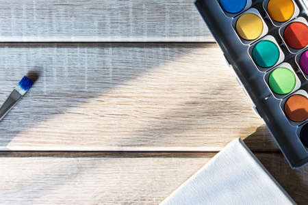 Brushes and malkasts on wooden backgroundの写真素材