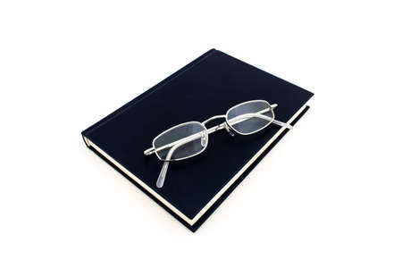 Blaues Buch mit Brille auf weissem hintergrundの写真素材