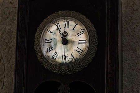 twelve o'clock on an old clockの写真素材