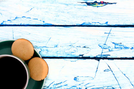 a cup of coffee with pastry on a blue white wooden backgroundの写真素材