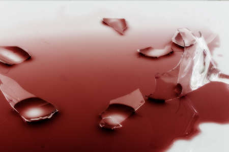 a broken wine glass on a white backgroundの写真素材