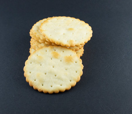 Salt biscuits on a black background