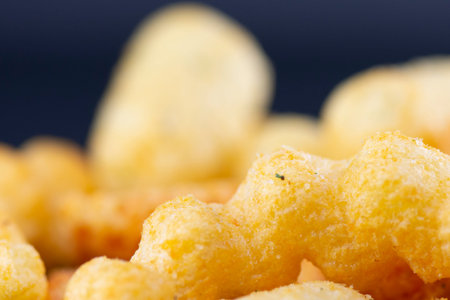 Potato chips with salt, cheese and garlic on a black background