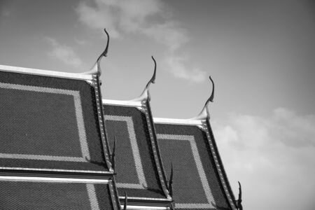 Delicate Thai art at top of roof of temple, Bangkok, Thailandのeditorial素材