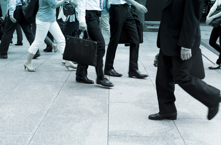 Business men walking on the pavementの写真素材