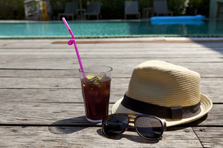 Glass of soda ,sunglasses and white sunhat.の写真素材
