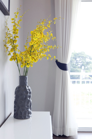 Yellow flowers in vaseの写真素材