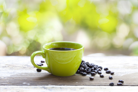 coffee cup and brown coffee beansの写真素材