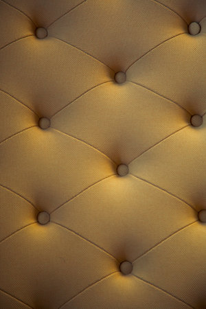 brown couch background texture with sunken buttons.