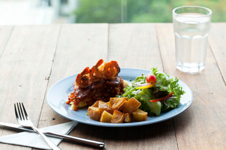 Flied potato with feta cheese and fried baconの写真素材