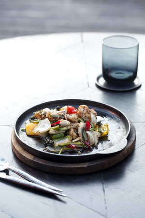 spicy sea bass fried with black pepper on iron plateの写真素材