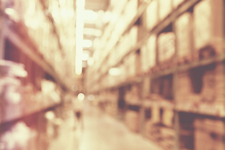 blurred image of boxes in factory warehouse with light leak filter.の写真素材