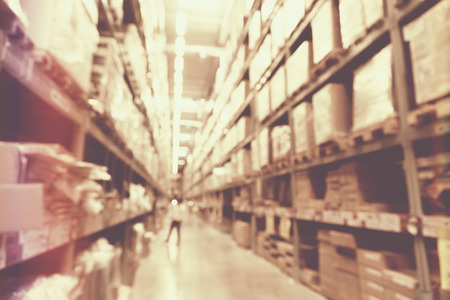 blurred image of boxes in factory warehouse with light leak filter.の写真素材
