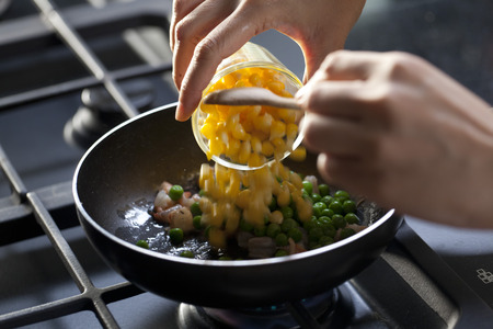 Mixed vegetable ingredients pan fried on stoveの写真素材
