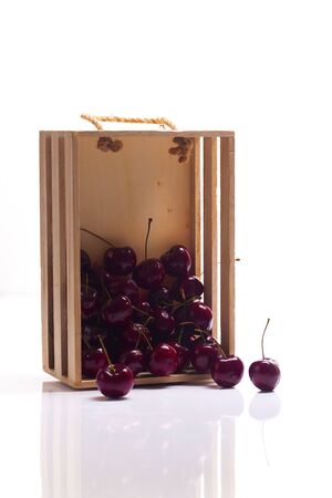 Handful of a red cherry on a white backgroundの写真素材