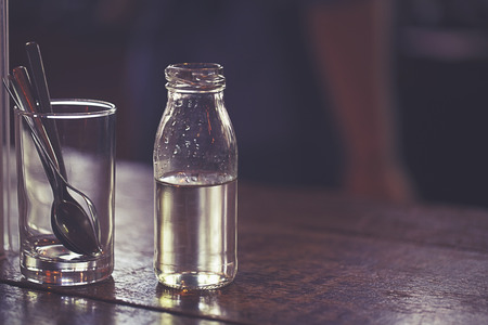 syrup in glass bottle on wooden tableの写真素材