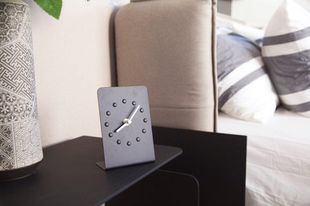 Alarm clock on bed side table