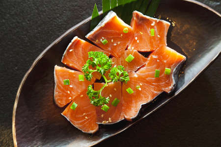 Fresh sliced salmon fish in plateの写真素材