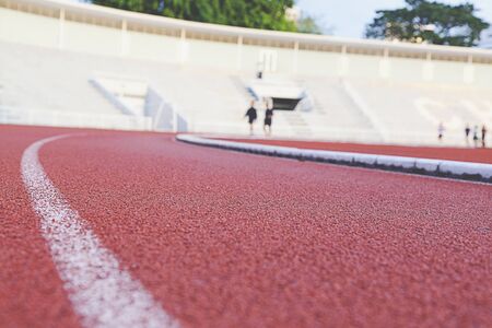 blurred image of a running track in a stadiumの写真素材