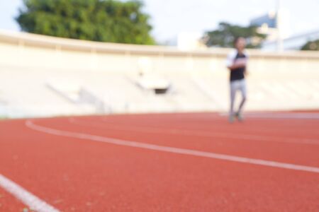 blurred image of a running track in a stadiumの写真素材