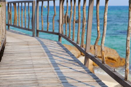 Beautiful rustic pier leading to wood gazebo,tropical seaの写真素材
