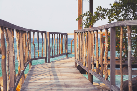 Beautiful rustic pier leading to wood gazebo,tropical seaの写真素材