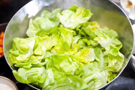 Slice of Green lettuce in a bowlの写真素材