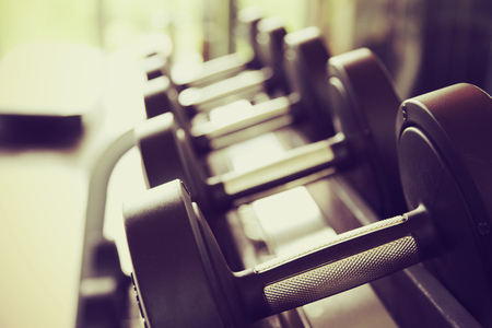 dumbbell in gym - vintage effect and sun flare filter effectの写真素材