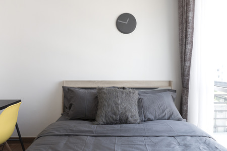 grey pillows on bedの写真素材