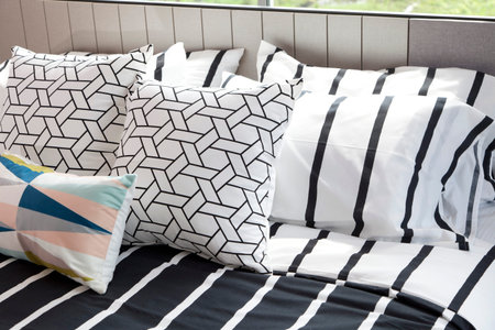 stylish bedroom interior design with pillows on bed