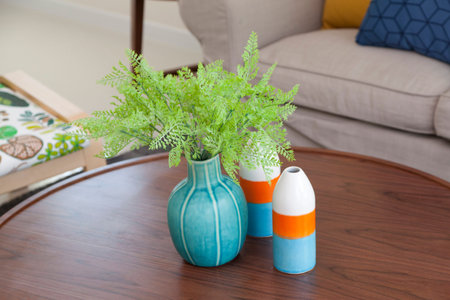 green plants in ceramic vase in living room on table
