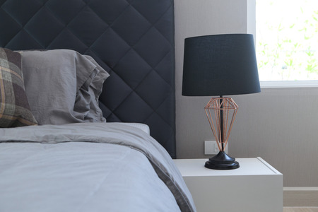black table lamp with grey bedding styleの写真素材