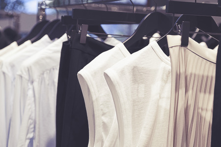 A row of clothes hanging on the rackの写真素材