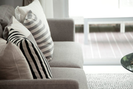 grey cushion on sofa