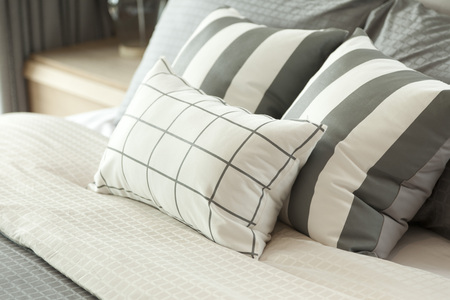 grey pillow on bedの写真素材